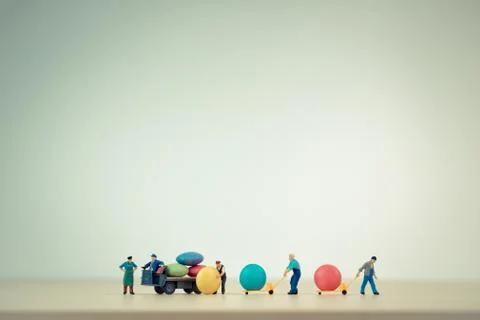 Workers unloading sugar coated chocolate candies from truck Stock Photos