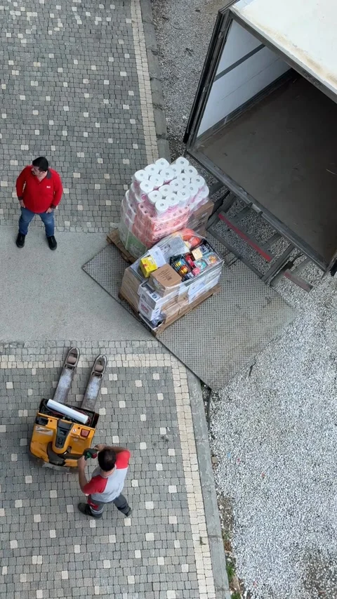 Workers unloading supplies from truck at warehouse delivery platform from o.. Stock Footage 336399141