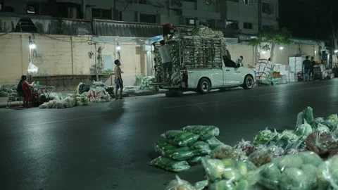 Workers Unloading a Truck with Fresh Vegetables in Bangkok at Night Stock Footage 320598288