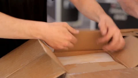 Workers unpack boxes in which there is professional lighting equipment Stock Footage 92222092