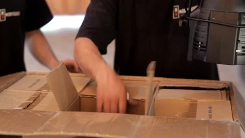 Workers unpack boxes in which there is professional lighting equipment Stock-Footage 92222165