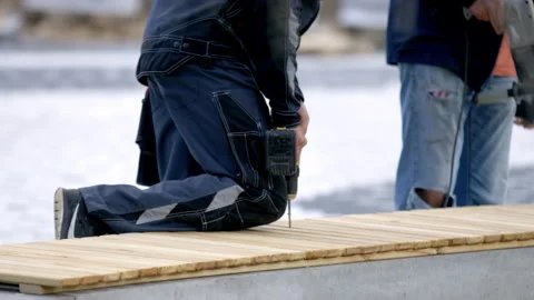 Workers use drill to make holes in bench wooden boards Stock Footage 246666804