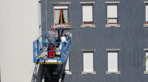 Workers use the lift to move and restore the facade Stock Footage 49369012