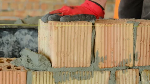 Workers use materials to create strong wall of building Stock Footage 317627730
