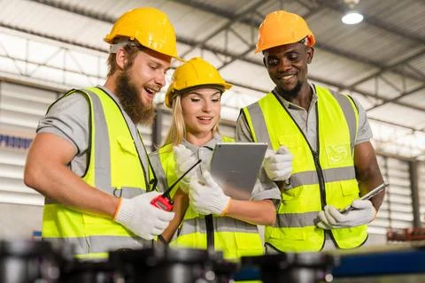 Workers use tablets team work in warehouses Stock Photos