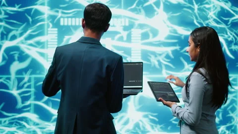 Workers using artificial intelligence deep learning to look at data Stock Footage 278626305