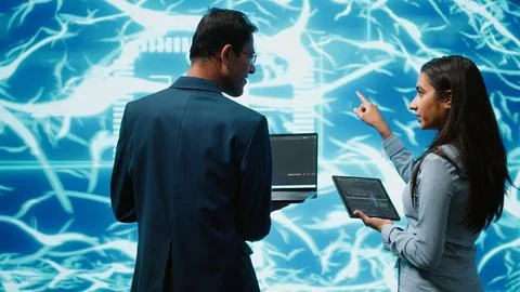 Workers using artificial intelligence deep learning to look at data 写真素材