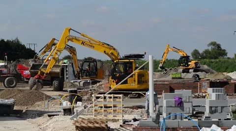 Workers using mechanical diggers building new houses selby United Kingdom Stock Footage 66534936