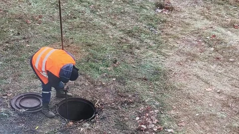 Workers using special tools remove blockages in the sewer, close-up, industry Stock Footage 303621735