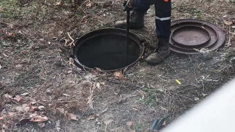 Workers using special tools remove blockages in the sewer, close-up, industry Stock Footage 304960220