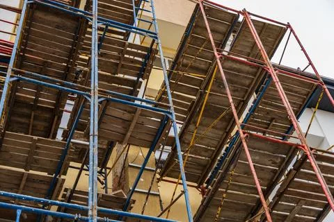 Workers utilize scaffolding systems for safe access during the construction.. Stock Photos