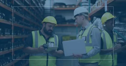 Workers in vests and helmets scanning inventory using scanner, checking on Fotos de archivo