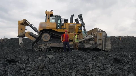 Workers In Vests Discuss Gold Mining Process Near Heavy Bulldozer Equipment Stock Footage 272784725