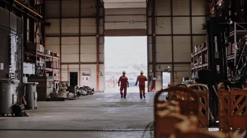 Workers walk around the workshop wearing overalls. Stock Footage 316162099