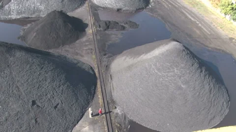 Workers walk between heaps of coal Stock Footage 56808259