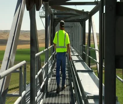 Workers walk on elevated Catwalk Stock Footage 21591636