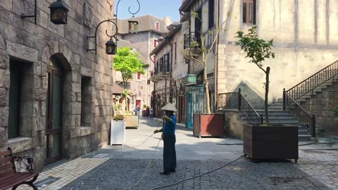 Workers walking around on street in front of old medieval European-styled castle Video stock 151239780