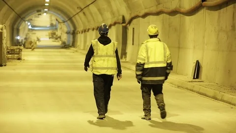 Workers walking at construction site of the underground tunnel Stock Footage