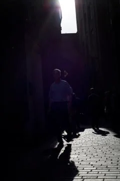 Workers walking down a cobbled lane Stock Photos