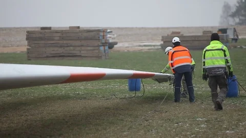 Workers Walking Near the Blades and Holding Rope Stock Footage 72185240