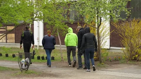 Workers walking towards the garden with tools Stock Footage 205922225