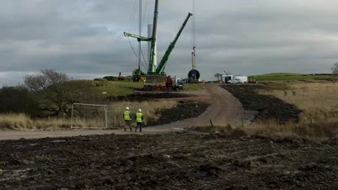 Workers walking to a wind turbine construction, 4K Stock Footage 179325236