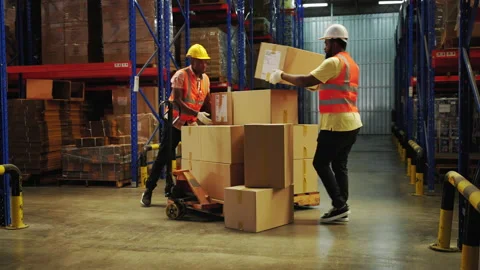 Workers in the warehouse are shaking hands to congratulate Stock Footage 231646744