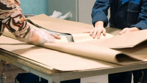 Workers in the warehouse pack the goods in paper before shipment Video stock 85408270