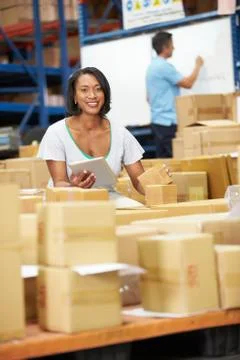 Workers in warehouse preparing goods for dispatch Foto stock