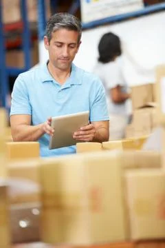 Workers in warehouse preparing goods for dispatch Foto stock