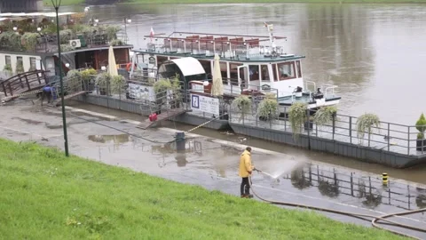 Workers wash mud and slit from the pavement. Stock Footage 141985132