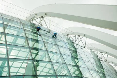 Workers wash Windows at height Stock Photos