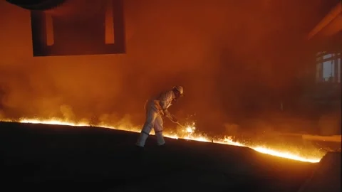 Workers wear high-temperature protective clothing to work at the blast furnace  Stockbeeldmateriaal 130885449