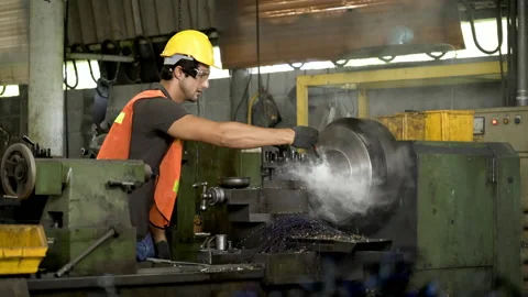 Workers wearing safety gear using a grinding machine steel in factory. Stock Footage 231105924
