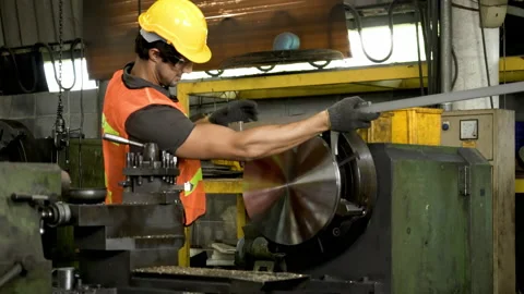 Workers wearing safety gear using a grinding machine steel in factory. Stock Footage 231106563