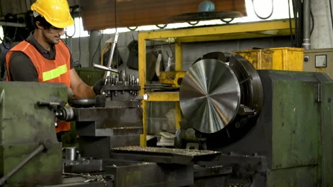 Workers wearing safety gear using a grinding machine steel in factory. Stock Footage 231106647