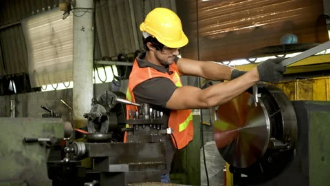 Workers wearing safety gear using a grinding machine steel in factory. Stock Footage 231106734
