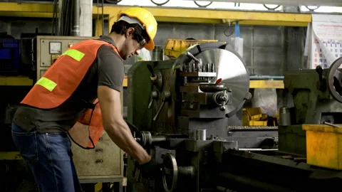Workers wearing safety gear using a grinding machine steel in factory. Stock Footage 231110064