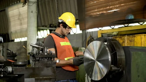 Workers wearing safety gear using a grinding machine steel in factory. Stock Footage 231110436