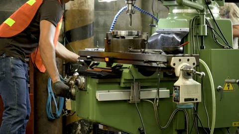 Workers wearing safety gear using a grinding machine steel in factory. Stock Footage 231110697