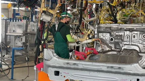 Workers weld and assemble various car parts. Hyundai factory. Stock Footage 174574664