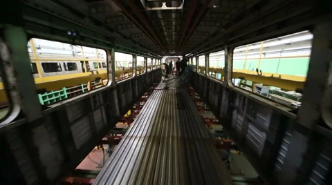 Workers weld inside dark train wagon at workshop in factory Stock Footage 32235088