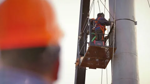 Workers weld pipes at high altitudes Stock Footage 142498260