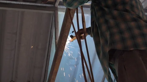 Workers weld steel structure with Electric welding machines in factory, Video stock 97480928