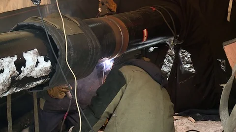 Workers welded oil pipe in the field Stock Footage 124636569