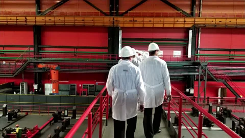 Workers in white coats are in the shop of the Chelyabinsk Pipe Rolling Plant Stock Footage 111405402