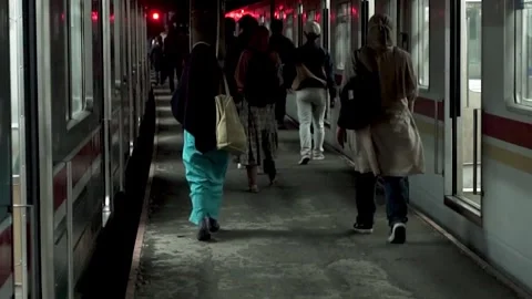 Workers who commute every day by train just got off the train at night Stock Footage 254069007
