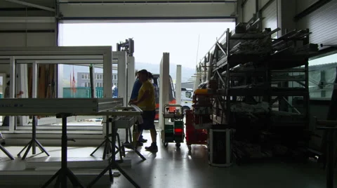 Workers in a window factory preparing a shipment to leave. Video stock 63026670