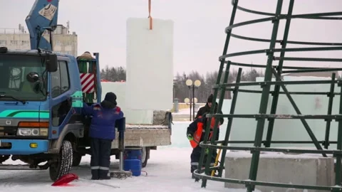 Workers in winter workwear installing ice panels Stock Footage 143688825