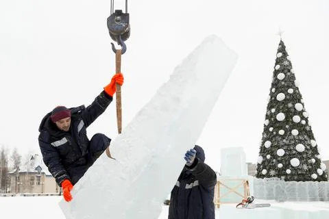 Workers in winter workwear installing ice panels 写真素材